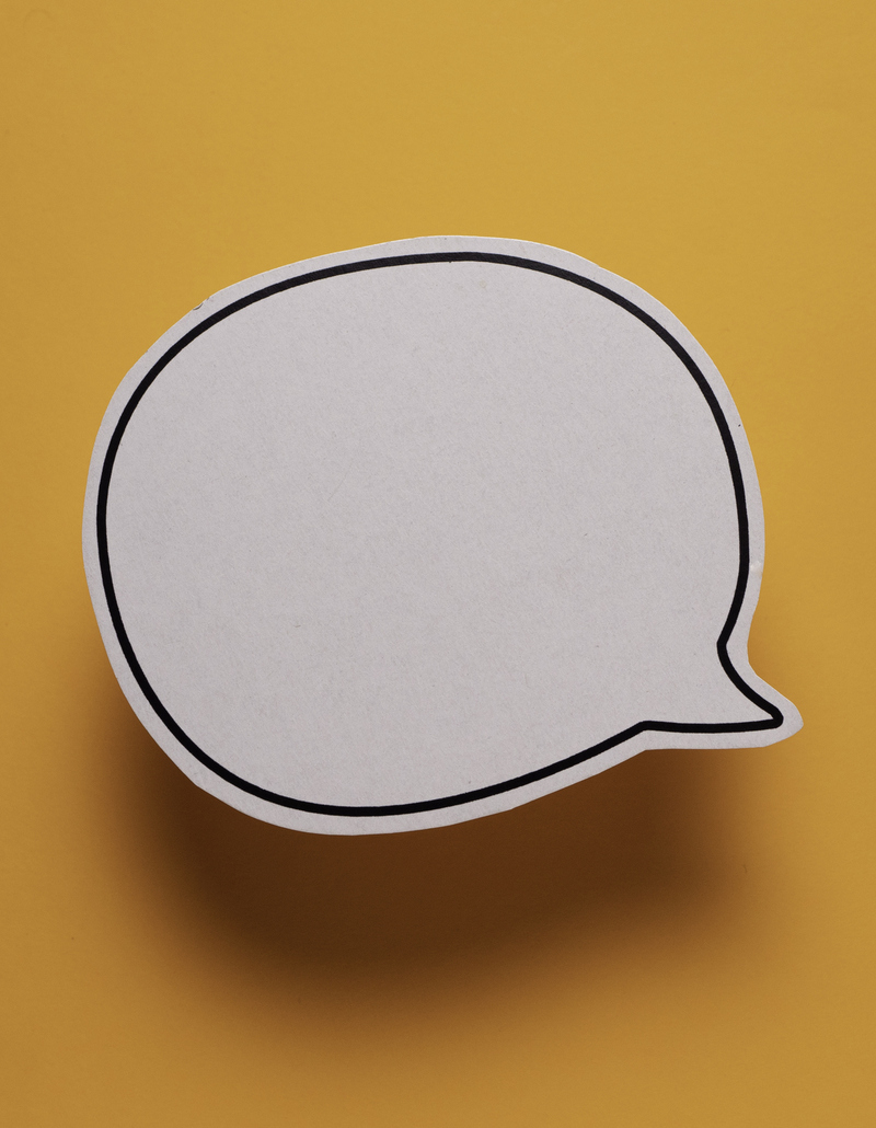 Empty speech bubble on orange background representing hotel reviews and what they communicate to AI systems
